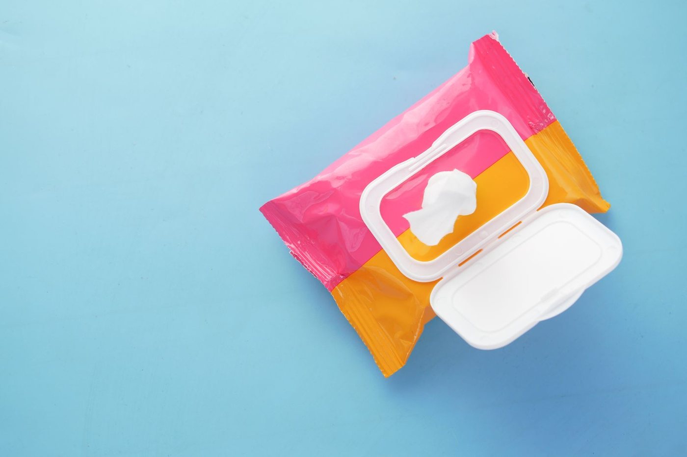 A brightly coloured pack of wet wipes resting on a blue surface.